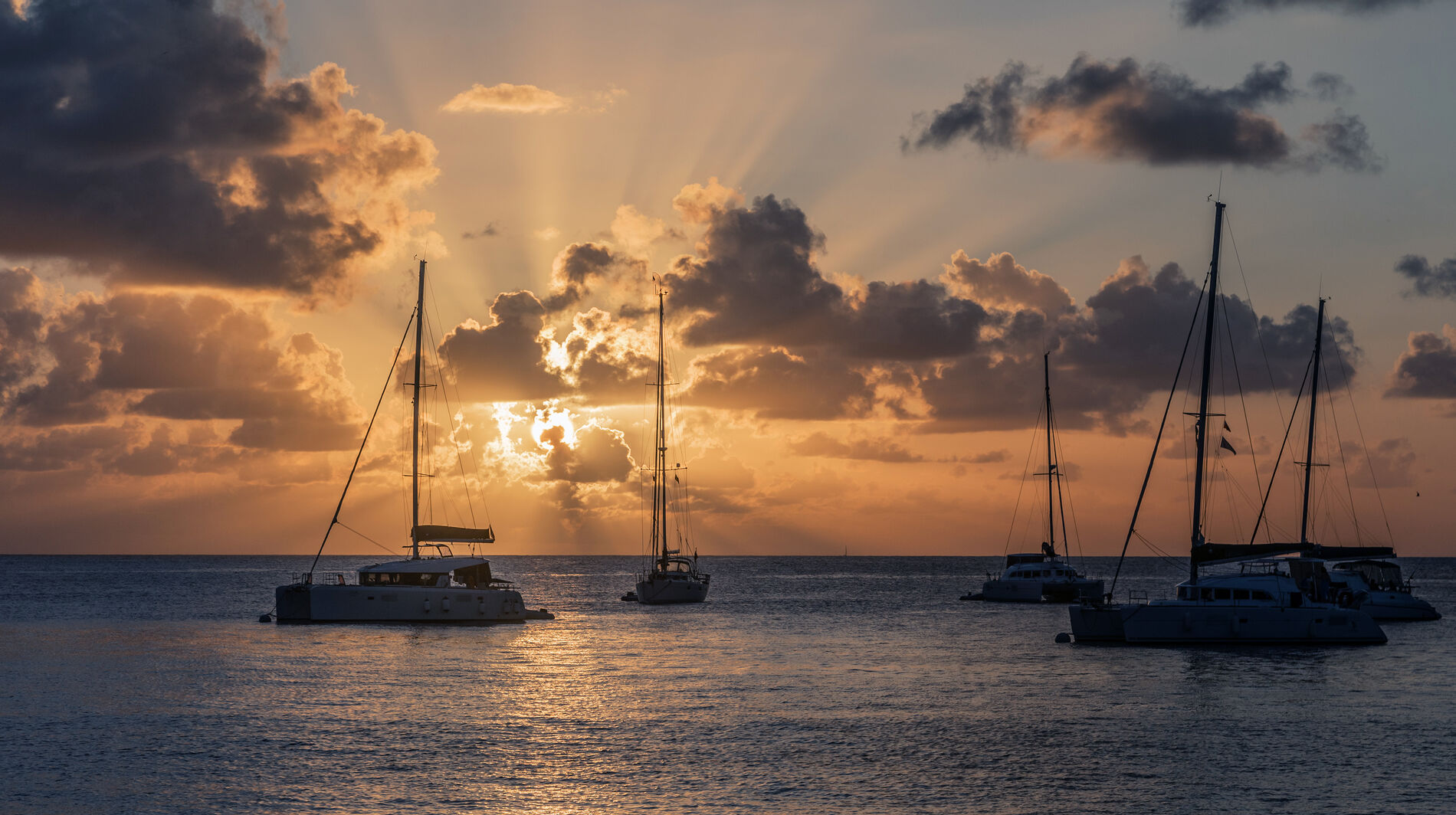 yachts anchored during sunset