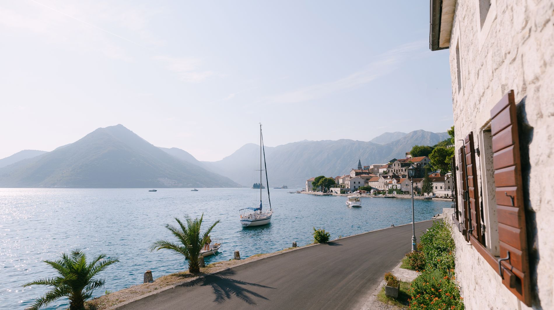 Perast coast with palm trees near the bay of kotor